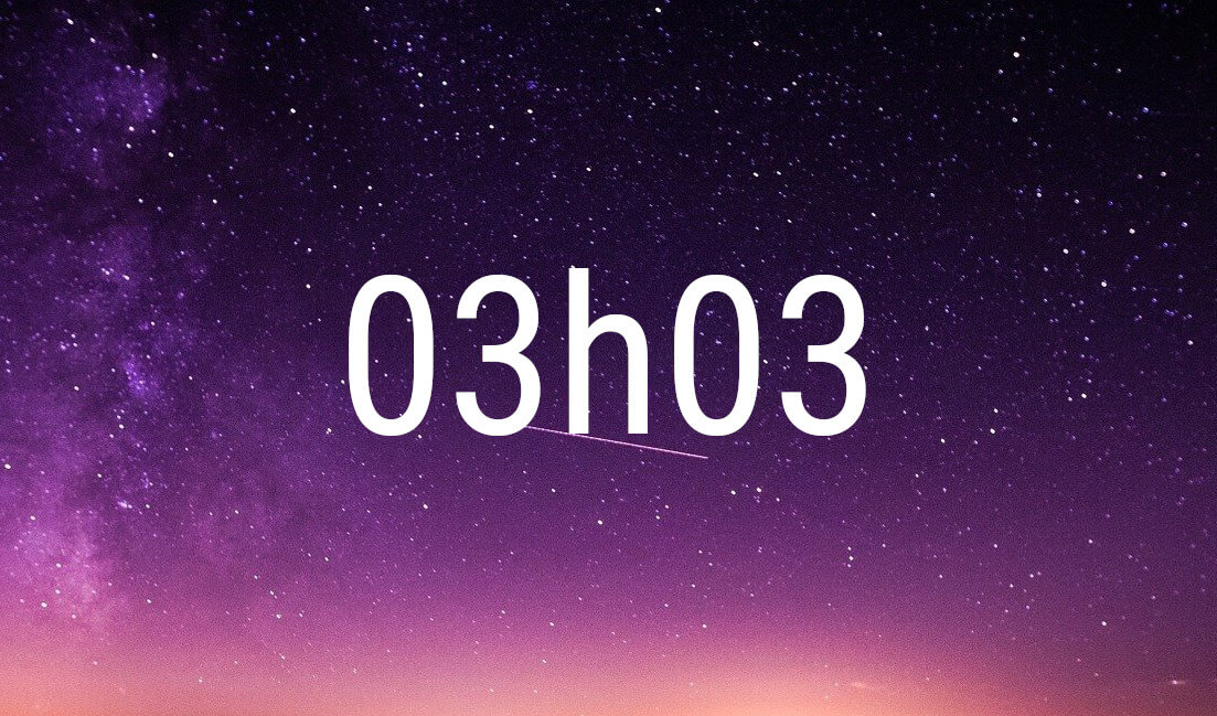 03:03 angel number in white digits on a starry purple night sky
